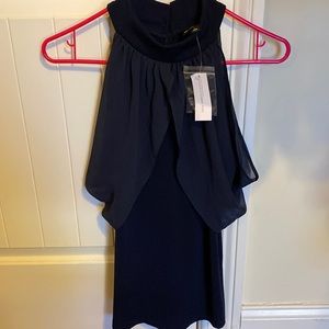 Sleeveless top, very cute button details and opening in the back!